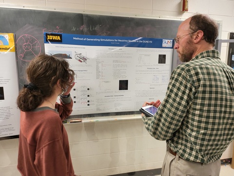 Prof. John Prineas judging Sarah Choate's poster at Acevedo Poster Contest 2024