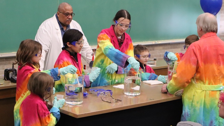 Kids perform science experiment at Demo Show with Vince Rodgers and Dale Stille