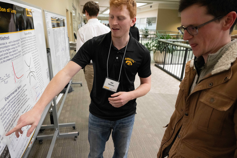 Will Meiners presents a poster at the UI Spring Undergraduate Research Festival