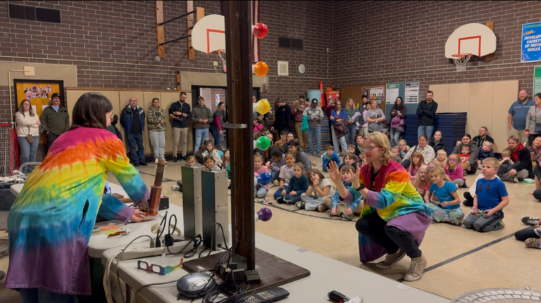 University of Iowa students perform a physics demo at a school