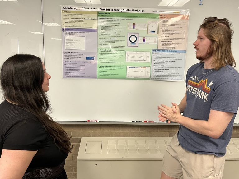 John Momberg discusses a poster at Acevedo Poster Contest