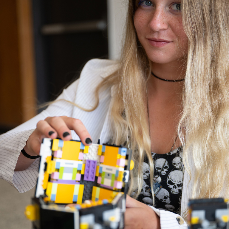 University of Iowa student Ava Reed with TRACERS LEGO model