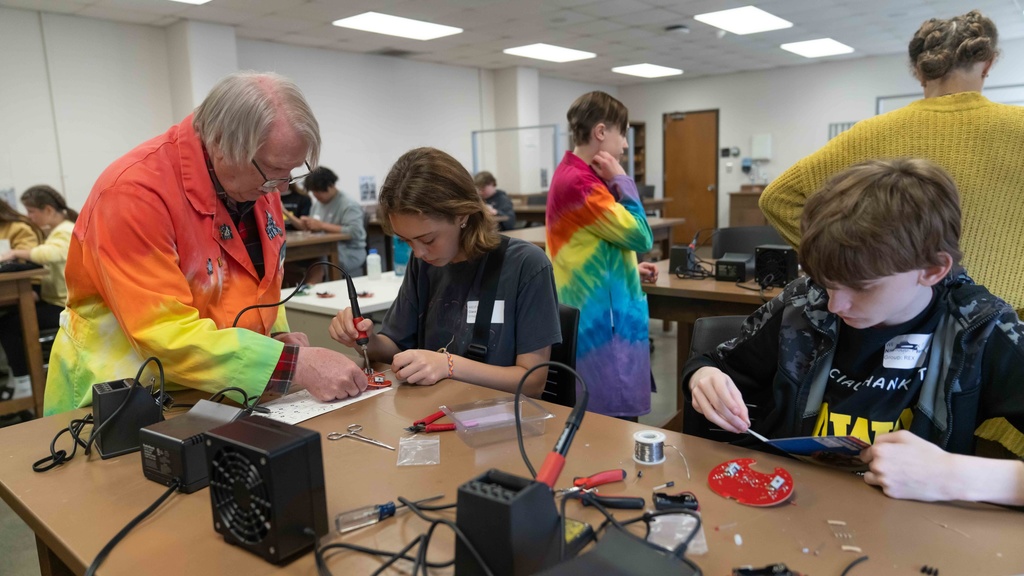 Dale Stille works with students' circuit board projects