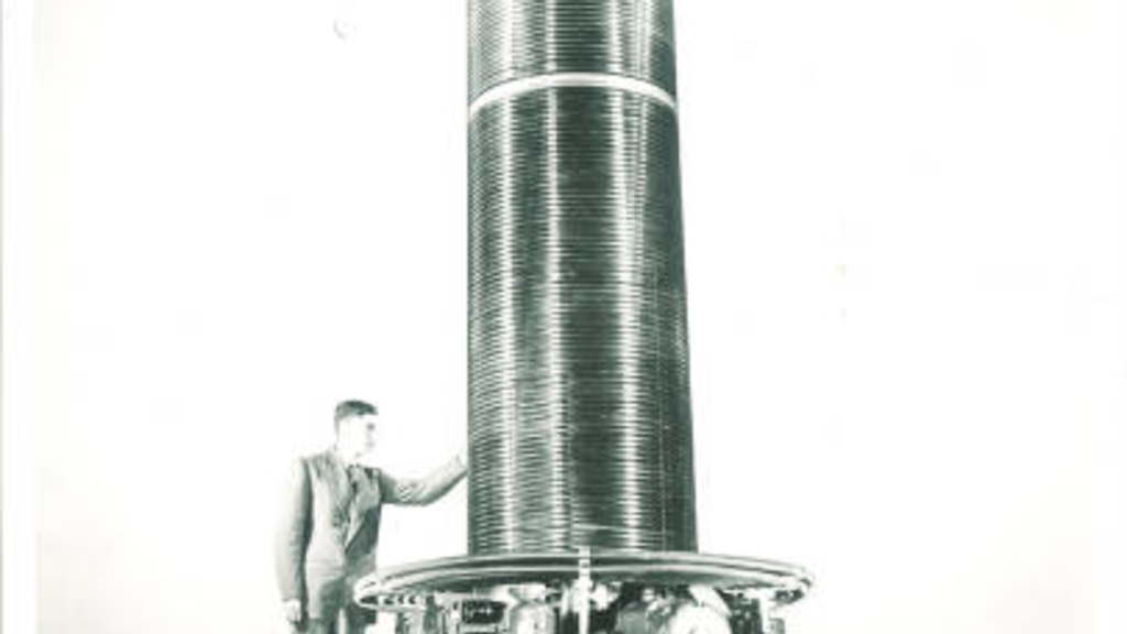 A University of Iowa physics student stands by a 5.5 MeV Van de Graaff accelerator,  1963