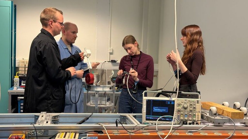 researchers working on the SWIM sensor in a lab